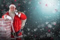 Composite image of portrait of santa claus carrying bag full of gifts Royalty Free Stock Photo