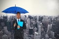 Composite image of portrait of serious businessman holding blue umbrella and file Royalty Free Stock Photo