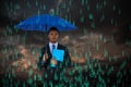Composite image of portrait of serious businessman holding blue umbrella and file Royalty Free Stock Photo