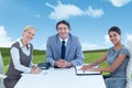 Composite image of portrait of smiling business people sitting at conference table Royalty Free Stock Photo