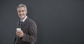 Composite image of portrait of smiling businessman holding mobile phone Royalty Free Stock Photo