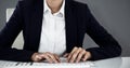 Composite image of portrait of smiling businesswoman typing on keyboard at desk Royalty Free Stock Photo