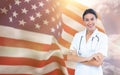 Composite image of portrait of smiling female doctor standing arms crossed Royalty Free Stock Photo