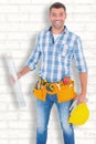 Composite image of portrait of smiling manual worker holding spirit level Royalty Free Stock Photo