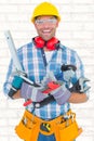 Composite image of portrait of smiling manual worker holding various tools Royalty Free Stock Photo