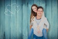 Composite image of portrait of smiling young couple piggybacking