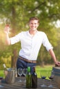 Composite image of portrait of smiling young man holding red wine glass by barrels Royalty Free Stock Photo