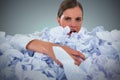 Composite image of portrait of unhappy businesswoman in heap crumpled paper