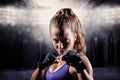 Composite image of portrait of woman with fighting stance Royalty Free Stock Photo