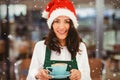 Composite image of portrait of woman with santa hat holding coffee Royalty Free Stock Photo