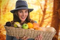 Composite image of portrait of young woman carrying fruits and vegetables in basket Royalty Free Stock Photo