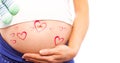 Composite image of pregnant woman holding baby shoes over bump Royalty Free Stock Photo