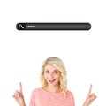 Composite image of pretty blonde smiling and pointing up Royalty Free Stock Photo