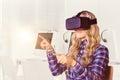 Composite image of pretty casual worker using oculus rift Royalty Free Stock Photo