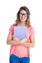 Composite image of pretty geeky hipster holding notepad Royalty Free Stock Photo