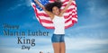 Composite image of pretty girl wrapped in american flag jumping and smiling at camera