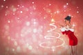 Composite image of pretty santa girl blowing over her hands Royalty Free Stock Photo