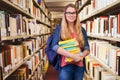 Composite image of pretty student in the library Royalty Free Stock Photo