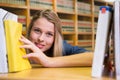 Composite image of pretty student in the library Royalty Free Stock Photo