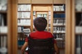 Composite image of rear view of boy sitting in wheelchair Royalty Free Stock Photo