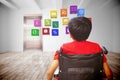 Composite image of rear view of boy sitting in wheelchair Royalty Free Stock Photo