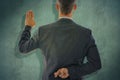 Composite image of rear view of businessman taking oath with fingers crossed Royalty Free Stock Photo