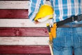 Composite image of rear view of handyman wearing tool belt Royalty Free Stock Photo