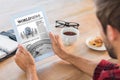 Composite image of rear view of man using tablet on wooden table Royalty Free Stock Photo