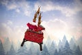 Composite image of rear view of santa claus riding on sled