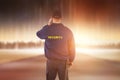 Composite image of rear view of security officer listening to earpiece Royalty Free Stock Photo