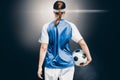 Composite image of rear view of woman soccer player holding a ball Royalty Free Stock Photo