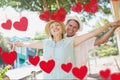 Composite image of red hanging hearts and mature couple dancing Royalty Free Stock Photo