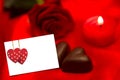 Composite image of red rose candle and chocolate hearts Royalty Free Stock Photo