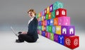 Composite image of redhead businesswoman using her laptop Royalty Free Stock Photo