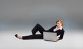Composite image of redhead businesswoman using her laptop Royalty Free Stock Photo