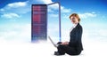 Composite image of redhead businesswoman using her laptop Royalty Free Stock Photo