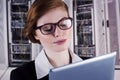 Composite image of redhead businesswoman using her tablet pc Royalty Free Stock Photo