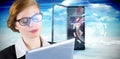 Composite image of redhead businesswoman using her tablet pc Royalty Free Stock Photo