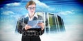 Composite image of redhead businesswoman using her tablet pc Royalty Free Stock Photo