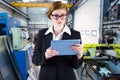 Composite image of redhead businesswoman using her tablet pc Royalty Free Stock Photo