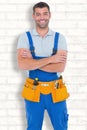 Composite image of repairman in overalls wearing tool belt standing arms crossed