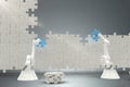 Composite image of robots arranging jigsaw pieces on puzzle 3d Royalty Free Stock Photo