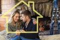 Composite image of romantic couple in front of lit fireplace