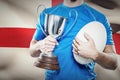 Composite image of rugby player holding trophy and ball Royalty Free Stock Photo