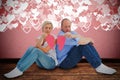 Composite image of sad mature couple holding a broken heart Royalty Free Stock Photo