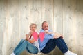 Composite image of sad mature couple holding a broken heart Royalty Free Stock Photo