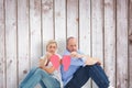 Composite image of sad mature couple holding a broken heart Royalty Free Stock Photo