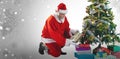 Composite image of santa claus arranging presents near christmas tree Royalty Free Stock Photo