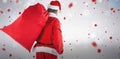 Composite image of santa claus carrying red bag full of gifts Royalty Free Stock Photo