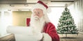 Composite image of santa claus checking his list Royalty Free Stock Photo